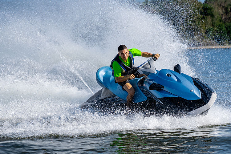 Person rides a jet ski at sea.